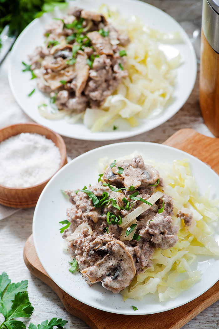 birds eye view of low carb beef stroganoff with two plates
