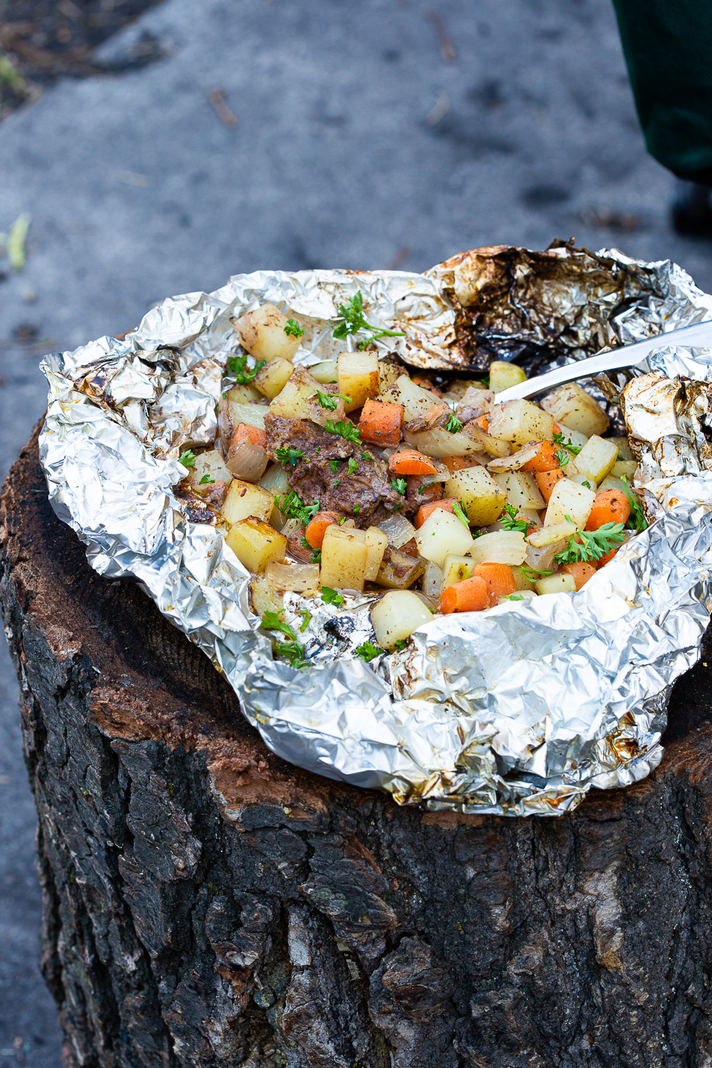 Making foil dinners in a campfire. 