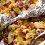 Easy to make foil packets with chicken, bacon, ranch, cheese, and potatoes.