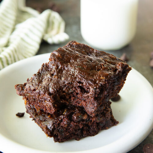 Zucchini brownies on a plate with a bite taken out